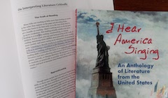A textbook titled "I Hear America Singing: An Anthology of Literature from the United States" with a picture of the Statue of Liberty on the cover. Beneath the textbook is an open page showing annotated notes.
