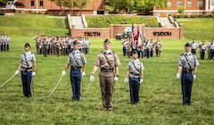 Five cadets stand at attention.