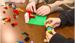Two students play with legos.