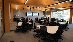 A classroom showing students sitting at round tables.