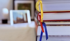 An image of four books stacked on top of each other.
